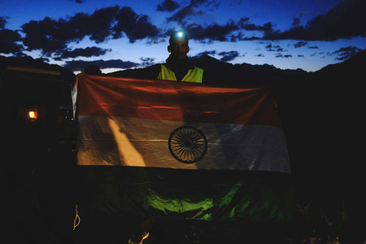 Parvez Malik holding the Indian flag at the start line of the sixth edition of La Ultra - The High.